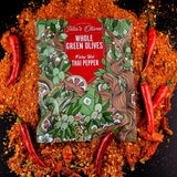 image of a bag of teta's olives fiery hot thai pepper laying on a bed of crushed red peppers, surrounded by red thai peppers