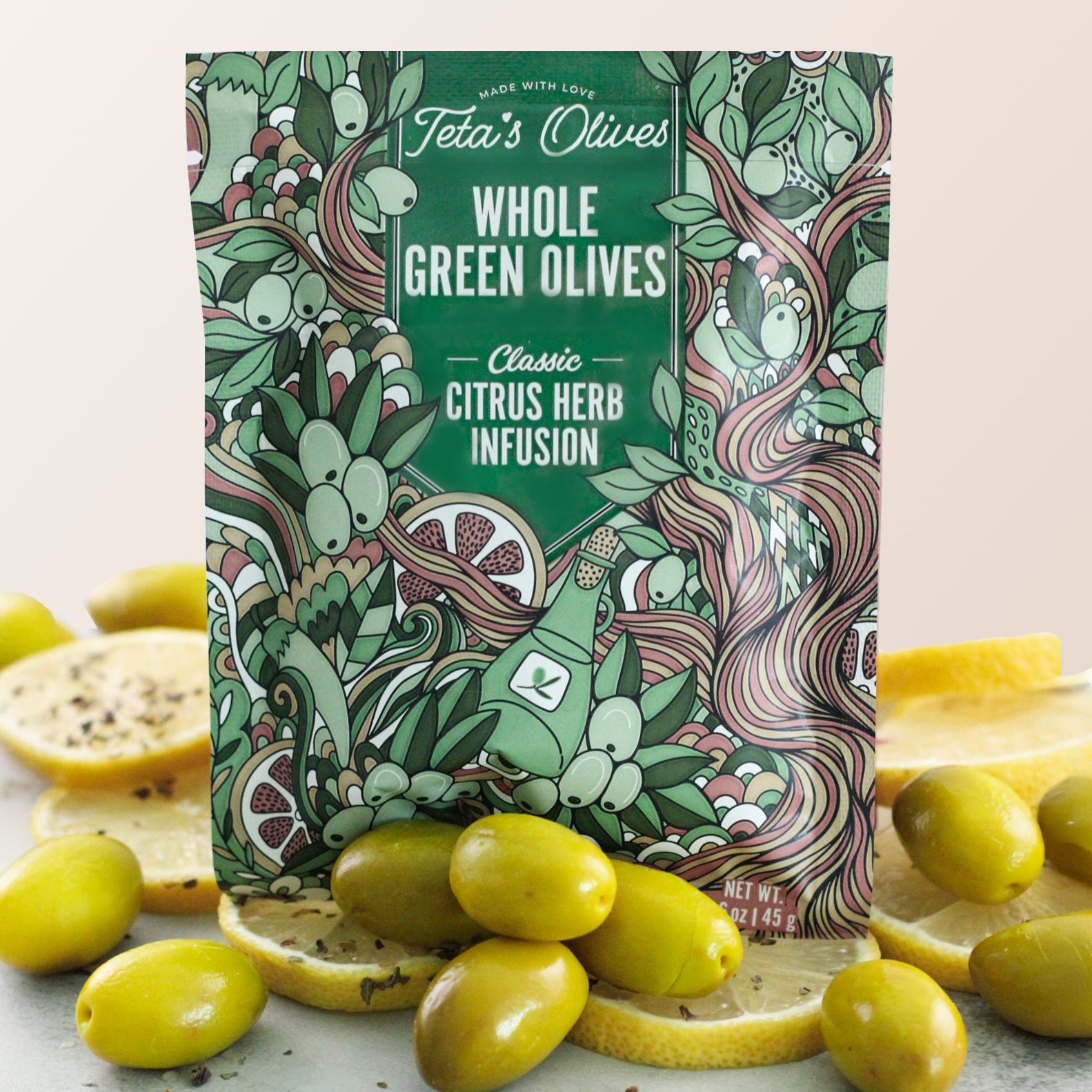 Close up of Teta's Olives Whole Green Olive Snacks, Citrus Herb Infusion flavor with olives and lemon slices surrounding the bag