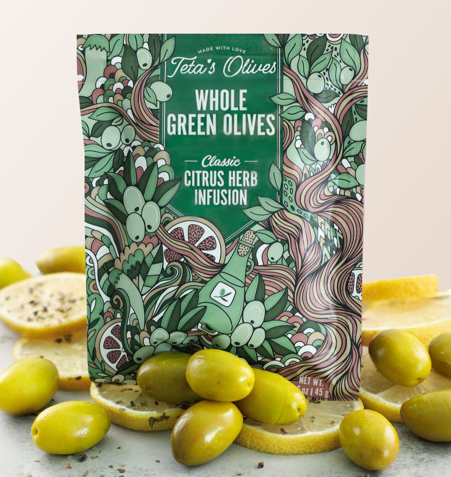 Close up of Teta's Olives Whole Green Olive Snacks, Citrus Herb Infusion flavor with olives and lemon slices surrounding the bag