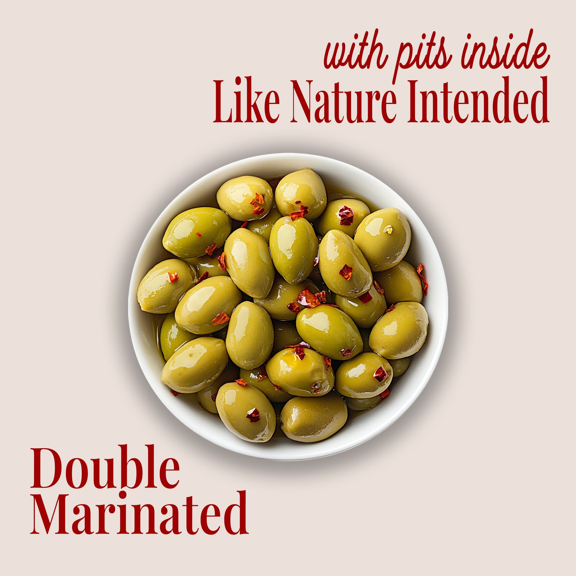image of a plate of whole green olives with crushed peppers, with text saying "with pits inside like nature intended" and "double marinated" with teta's olives logo