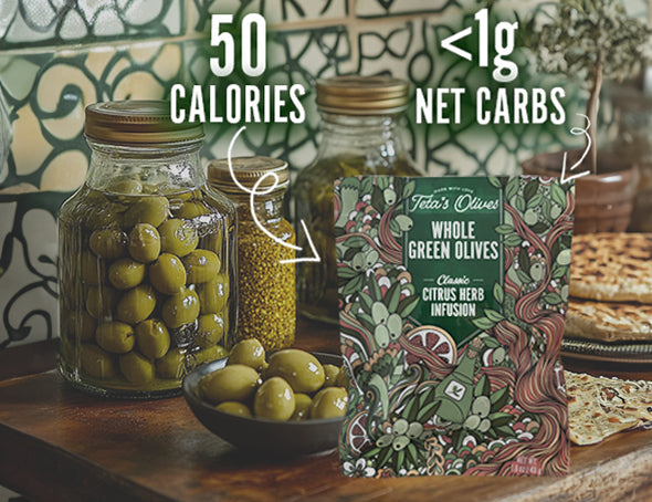 front view of teta's olives classic citrus herb infusion snack bag on a kitchen counter with jars and a bowl of green olives. text saying "50 calories" and "<1g net carbs" pointing at the bag