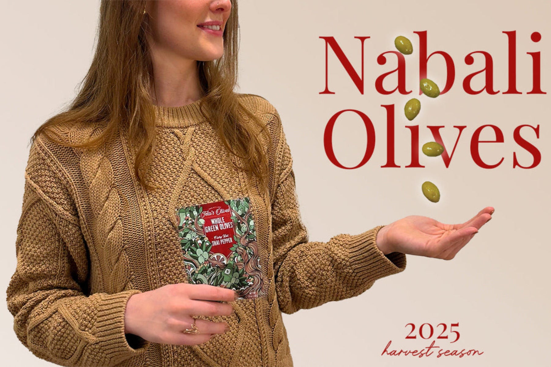 Person holding a bag of Teta's Olives spicy thai pepper green olives with 'Nabali Olives' branding and '2025 harvest season' text.