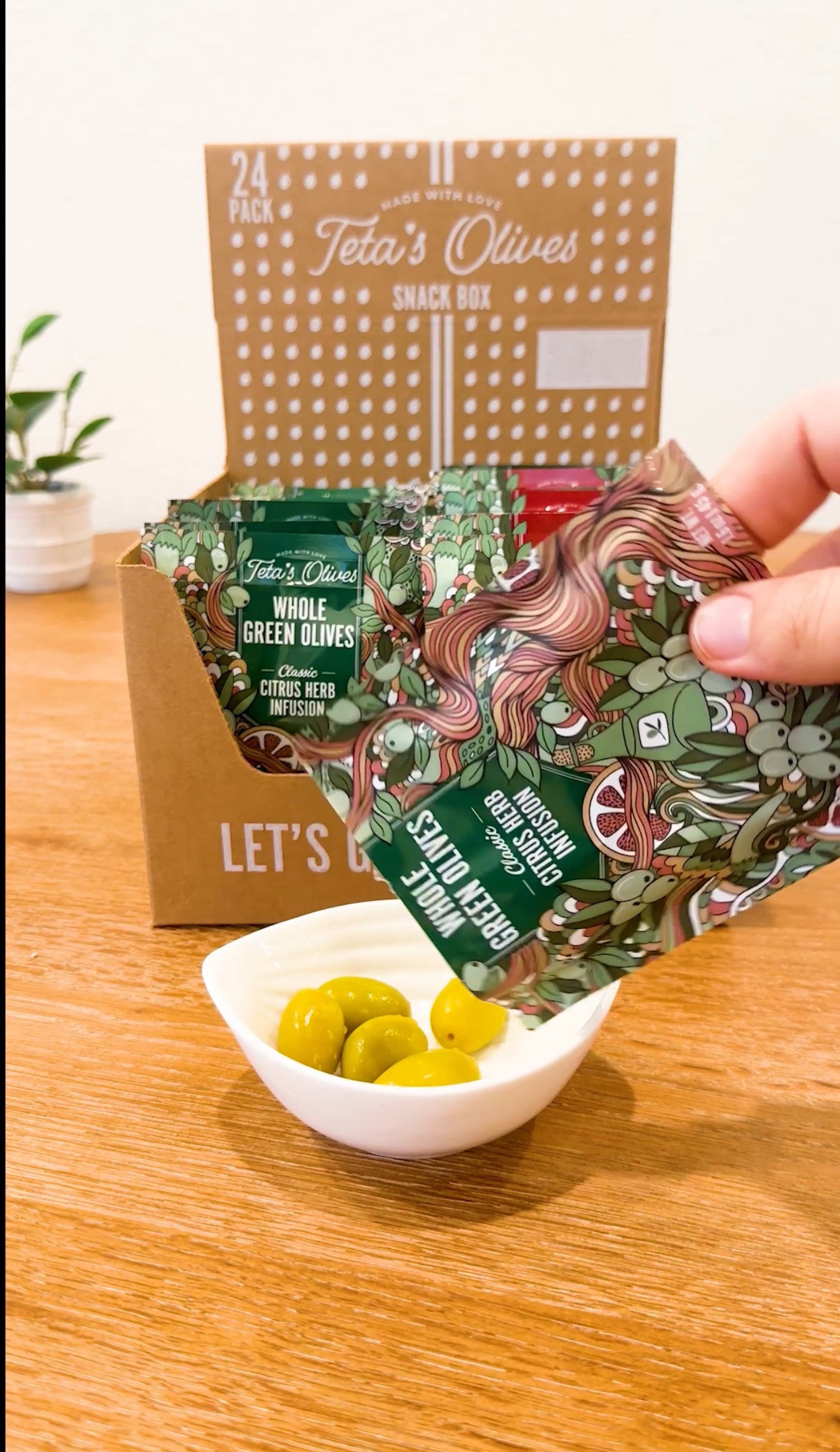 Unboxing video of 24 pack variety box. Bag is torn open revealing vibrant cracked green olives. 