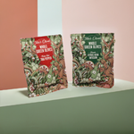 2 bags of teta's olives snack bags (classic citrus herb infusion and fiery hot thai pepper), against a multi-color pastel background, front view, close up
