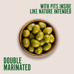 image of a plate of whole green olives, with text saying "with pits inside like nature intended" and "double marinated" with teta's olives logo