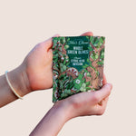 teta's olives, close up, classic citrus herb infusion snack bag, in hands against a nature background